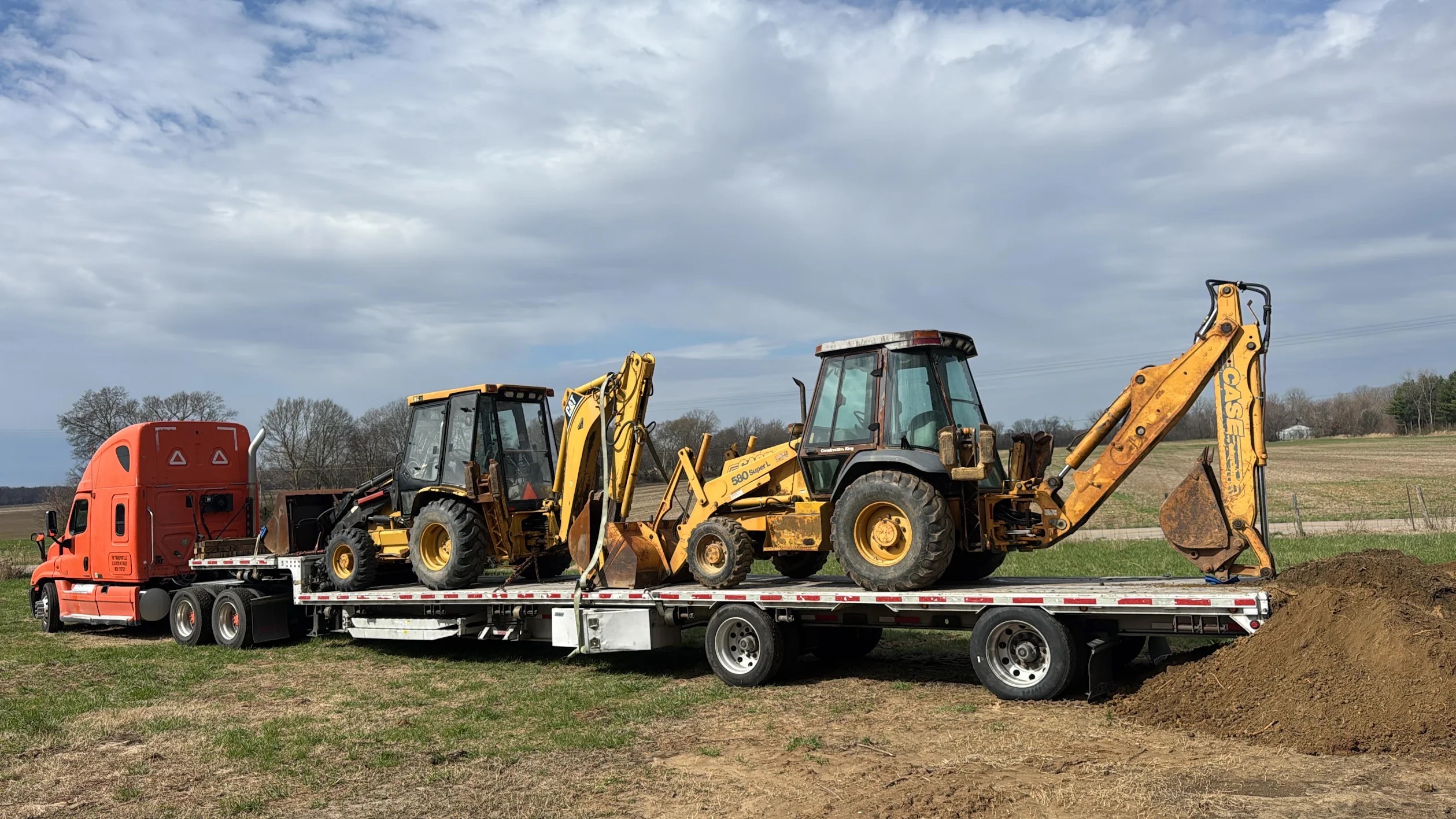 Backhoes on flatbed trailer